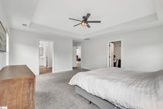 153 Coppermine Dr, Easley, SC 29642 - bedroom featuring a tray ceiling, carpet flooring, baseboards, a walk in closet, and ceiling fan