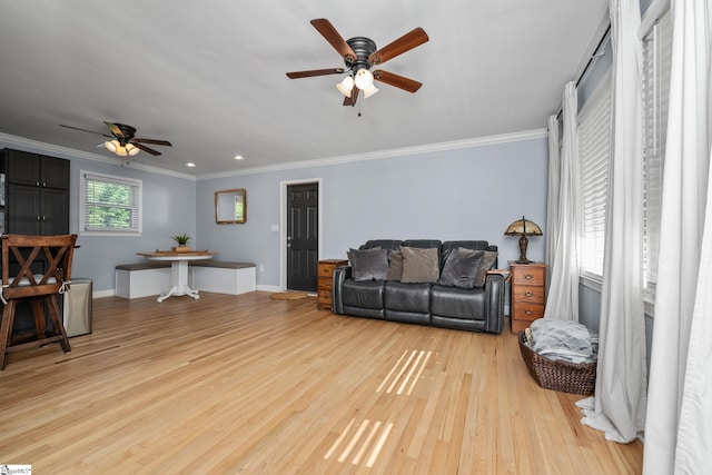 living room with a ceiling fan, crown molding, light wood-style floors, baseboards, and recessed lighting