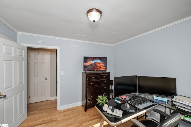 office area with ornamental molding, light wood-style floors, and baseboards