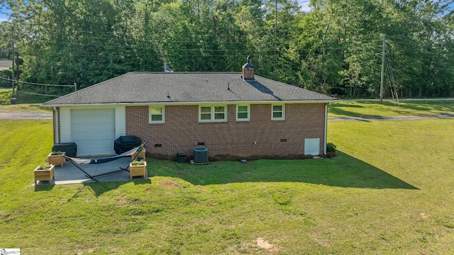 rear view of house featuring crawl space, a chimney, brick siding, and a yard