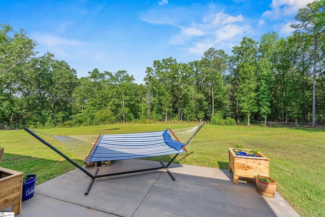view of patio featuring a forest view