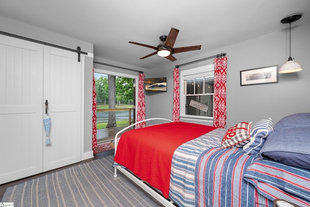 653 R B Baker Dr, Chapin, SC 29036 - carpeted bedroom with a barn door, a ceiling fan, and baseboards