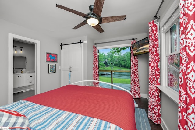 653 R B Baker Dr, Chapin, SC 29036 - bedroom featuring wood finished floors, a barn door, connected bathroom, baseboards, and ceiling fan