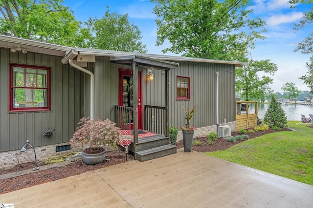 653 R B Baker Dr, Chapin, SC 29036 - entrance to property featuring a water view, board and batten siding, a yard, a patio area, and crawl space