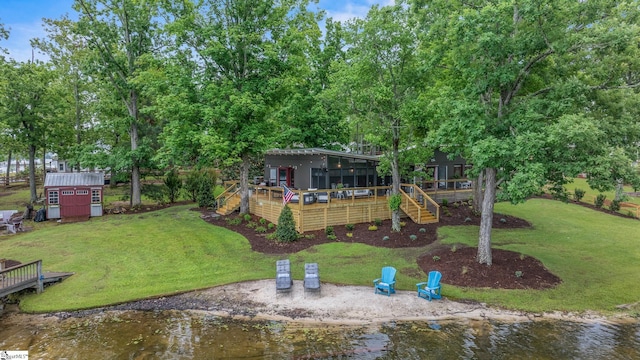 653 R B Baker Dr, Chapin, SC 29036 - view of grassy yard featuring a deck with water view, an outdoor structure, a storage unit, stairway, and a sunroom