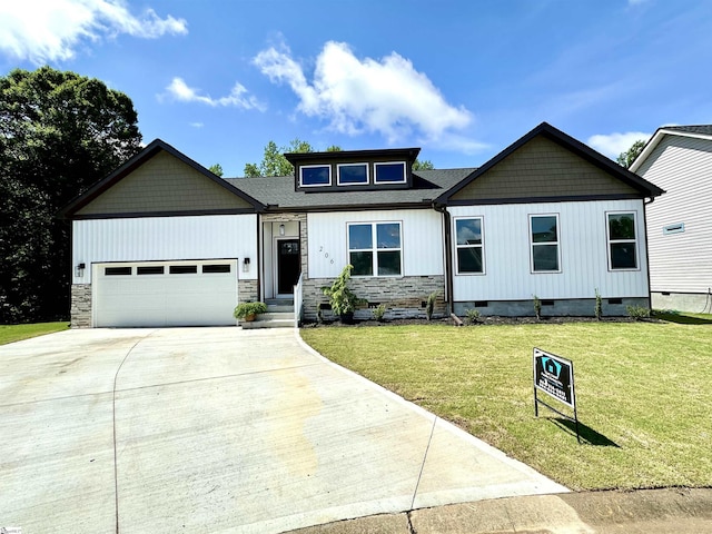 view of front facade with concrete driveway, an attached garage, stone siding, and a front yard