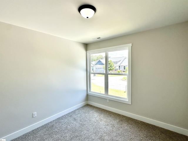 unfurnished room featuring baseboards and light carpet