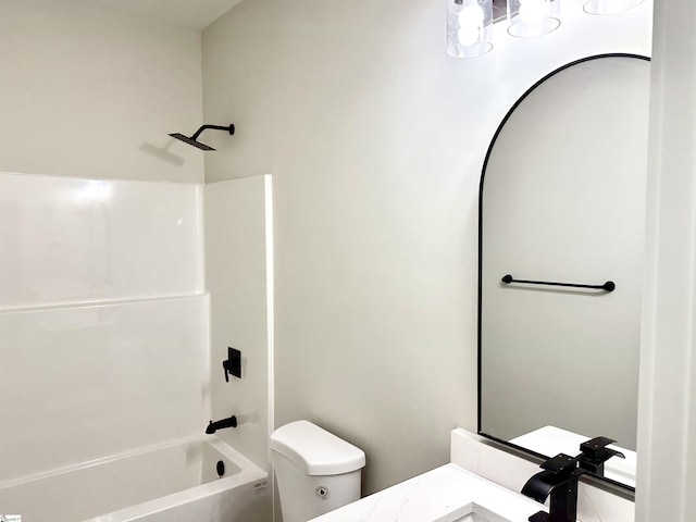 bathroom with toilet, shower / tub combination, and vanity