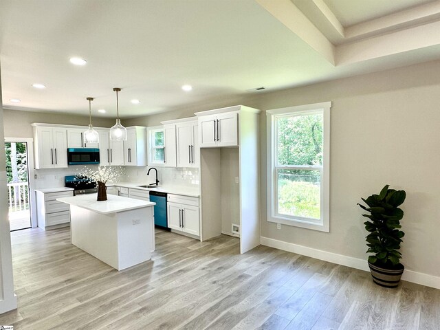 kitchen with dishwasher, stove, a sink, white cabinetry, and tasteful backsplash