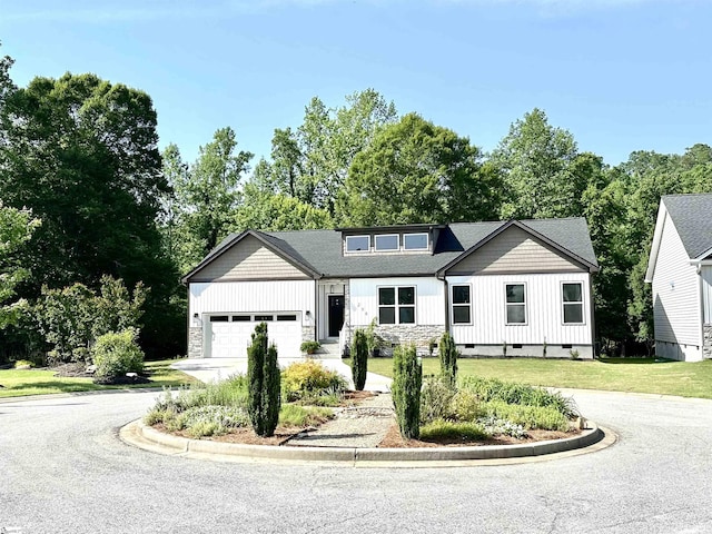 view of front facade featuring driveway, an attached garage, crawl space, a front lawn, and board and batten siding
