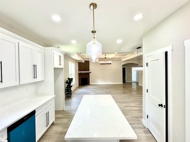kitchen featuring dishwashing machine, recessed lighting, light wood finished floors, and light stone countertops