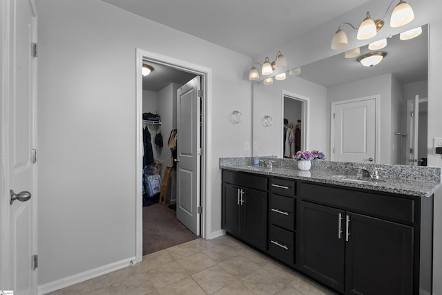 605 Mosque Ln, Lyman, SC 29365 - bathroom featuring double vanity, a walk in closet, tile patterned floors, and baseboards