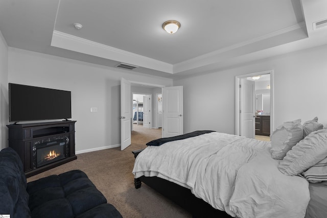 605 Mosque Ln, Lyman, SC 29365 - carpeted bedroom featuring a raised ceiling, ornamental molding, baseboards, a glass covered fireplace, and connected bathroom