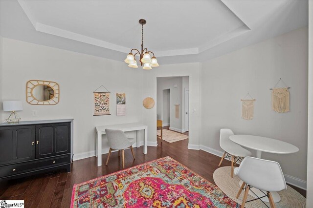 6 Kelvyn St, Greer, SC 29651 - dining room featuring a tray ceiling, a chandelier, dark wood-style flooring, and baseboards