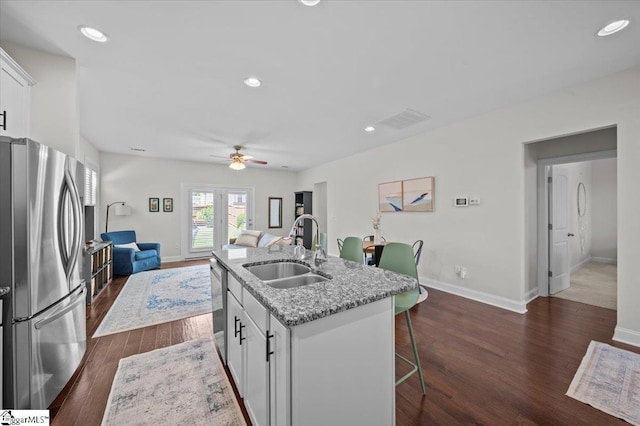 6 Kelvyn St, Greer, SC 29651 - kitchen featuring appliances with stainless steel finishes, a sink, a breakfast bar, a ceiling fan, and dark wood finished floors