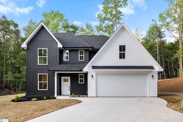 modern farmhouse featuring roof with shingles, driveway, board and batten siding, and an attached garage