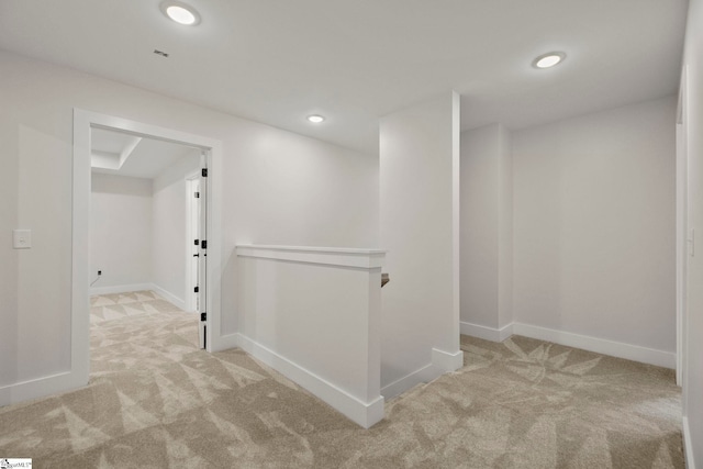 corridor with carpet, an upstairs landing, baseboards, and recessed lighting