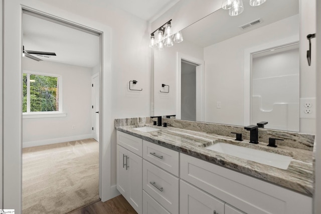 full bathroom featuring double vanity, baseboards, wood finished floors, and a ceiling fan