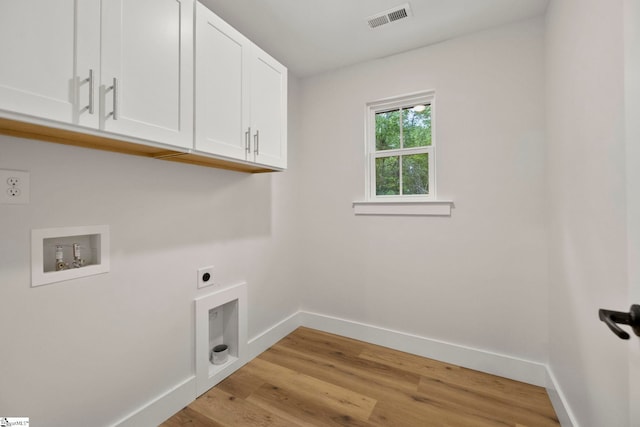 laundry area with cabinet space, hookup for an electric dryer, baseboards, washer hookup, and light wood-type flooring