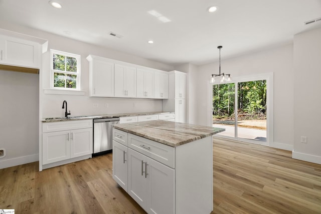 kitchen with stainless steel dishwasher, a sink, light wood-type flooring, white cabinetry, and recessed lighting