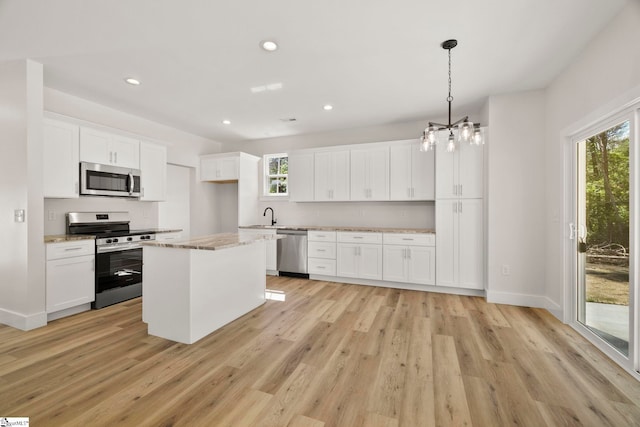 kitchen with stainless steel appliances, decorative backsplash, light wood-style flooring, a sink, and recessed lighting