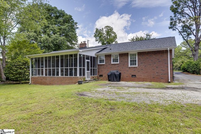 202 Roberta Dr, Greenville, SC 29615 - back of property with a sunroom, a chimney, brick siding, a lawn, and crawl space