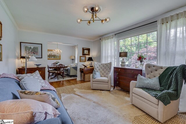 202 Roberta Dr, Greenville, SC 29615 - living room featuring a chandelier, wood finished floors, and ornamental molding