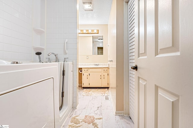251 Cherokee Dr, Fair Play, SC 29643 - full bathroom featuring marble look tile flooring, walk in shower, vanity, and a textured ceiling