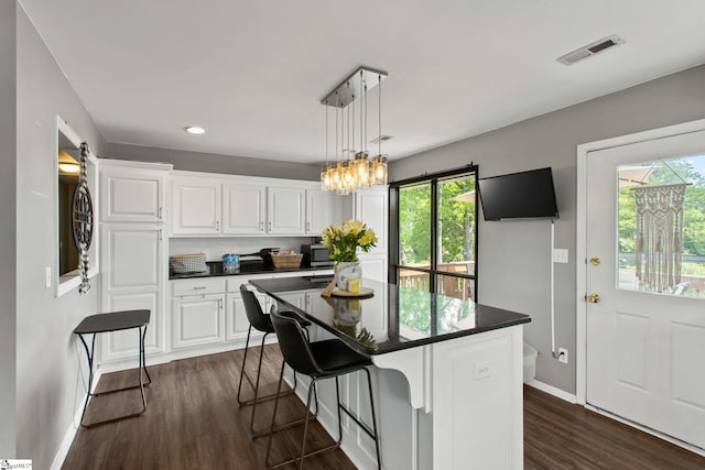 7 Bendingwood Cir, Taylors, SC 29687 - kitchen with dark countertops, healthy amount of natural light, white cabinets, and recessed lighting