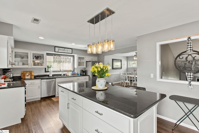 7 Bendingwood Cir, Taylors, SC 29687 - kitchen featuring stainless steel appliances, healthy amount of natural light, dark wood finished floors, glass insert cabinets, and recessed lighting