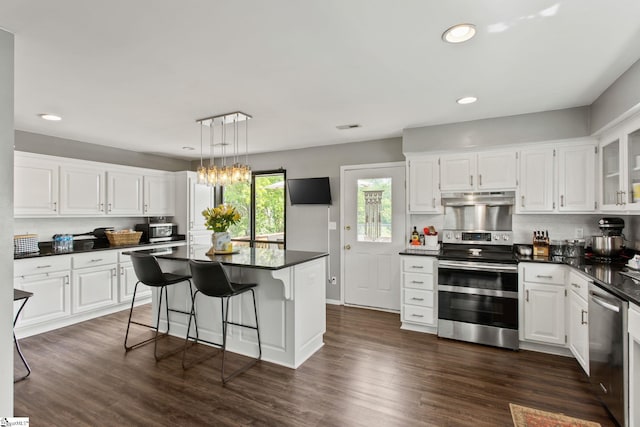 7 Bendingwood Cir, Taylors, SC 29687 - kitchen with appliances with stainless steel finishes, under cabinet range hood, dark countertops, white cabinetry, and recessed lighting