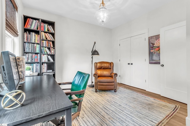 office area with wood finished floors and a chandelier