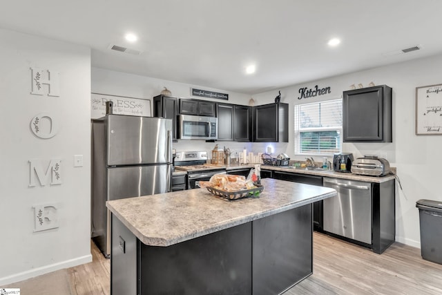 625 Mccormick Ln, Lyman, SC 29365 - kitchen with appliances with stainless steel finishes, a center island, light countertops, light wood-style floors, and baseboards