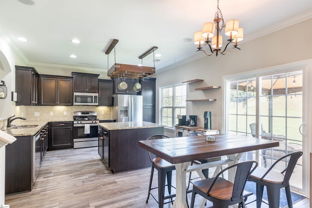 110 Avendell Dr, Easley, SC 29642 - kitchen featuring stainless steel appliances, a sink, dark brown cabinets, a kitchen island, and a chandelier