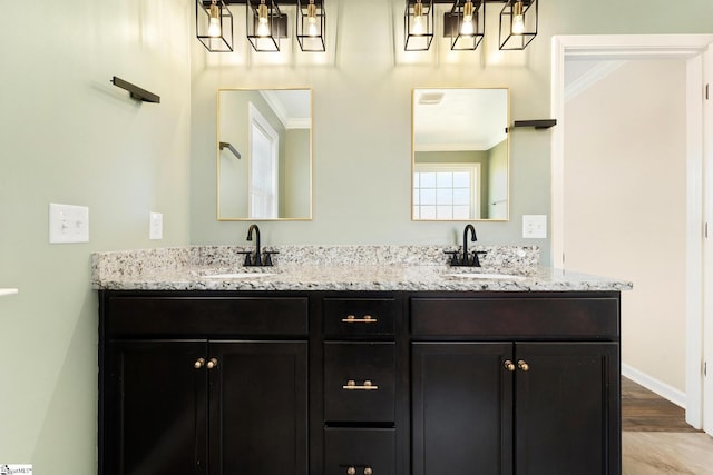110 Avendell Dr, Easley, SC 29642 - full bath featuring ornamental molding, a chandelier, double vanity, wood finished floors, and baseboards