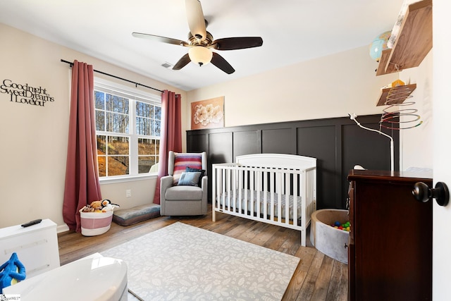 110 Avendell Dr, Easley, SC 29642 - bedroom with hardwood / wood-style flooring, a crib, a ceiling fan, and a decorative wall