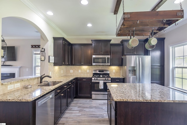 110 Avendell Dr, Easley, SC 29642 - kitchen with appliances with stainless steel finishes, a sink, arched walkways, light wood finished floors, and light stone counters