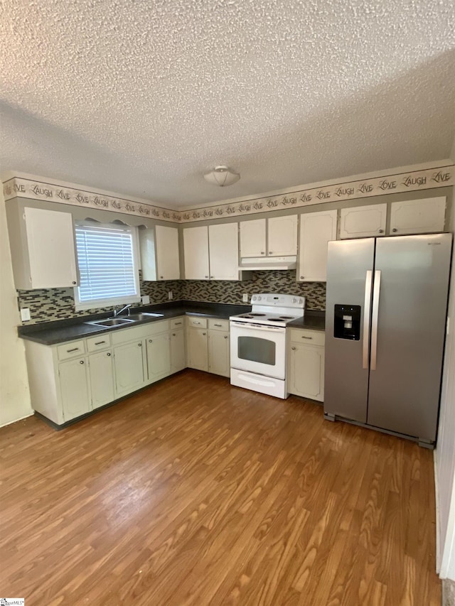6 Powell Cir, Inman, SC 29349 - kitchen with stainless steel refrigerator with ice dispenser, electric range, under cabinet range hood, a sink, and dark countertops