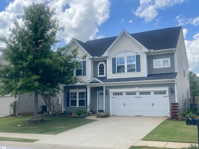 374 Bucklebury Rd, Greer, SC 29651 - view of front facade featuring a garage, a front lawn, driveway, and a shingled roof