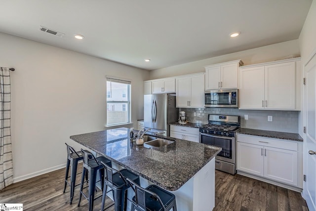 115 Slateford Cir, Piedmont, SC 29673 - kitchen featuring appliances with stainless steel finishes, a sink, a kitchen island with sink, white cabinetry, and decorative backsplash
