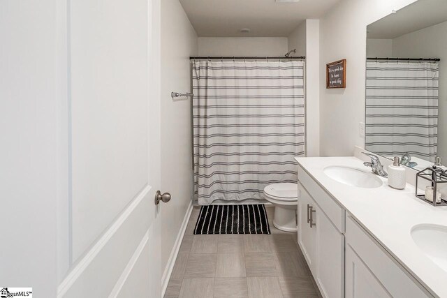 115 Slateford Cir, Piedmont, SC 29673 - bathroom featuring toilet, double vanity, baseboards, and curtained shower