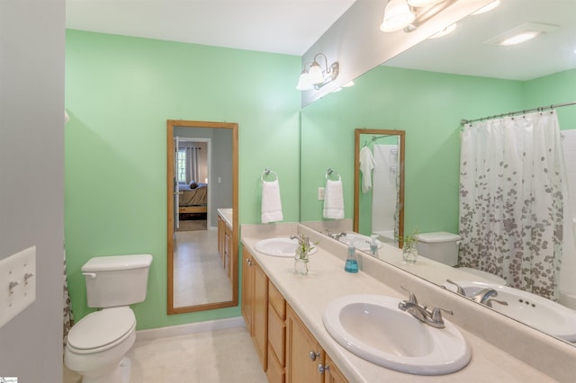 105 Bitternut Ln, Taylors, SC 29687 - bathroom featuring connected bathroom, toilet, double vanity, and baseboards