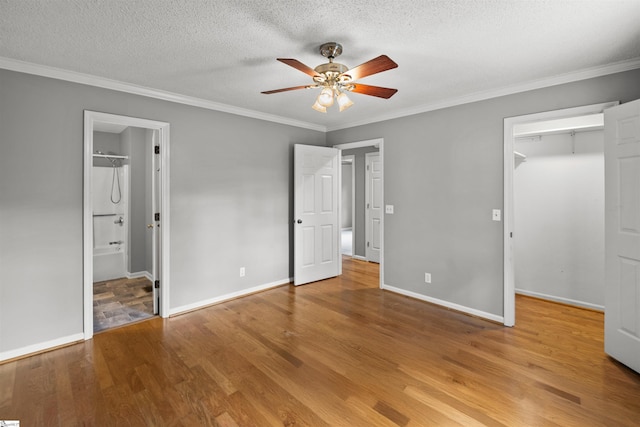32 Circleview Dr, Taylors, SC 29687 - unfurnished bedroom featuring a spacious closet, wood finished floors, crown molding, baseboards, and a closet