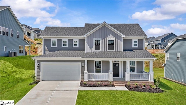 craftsman-style home with a porch, board and batten siding, driveway, cooling unit, and a front lawn