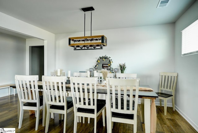dining area featuring dark wood-style floors and baseboards