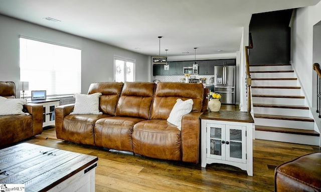 living room featuring stairway and hardwood / wood-style floors