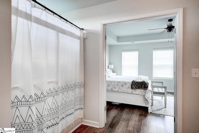 bedroom featuring wood finished floors and baseboards