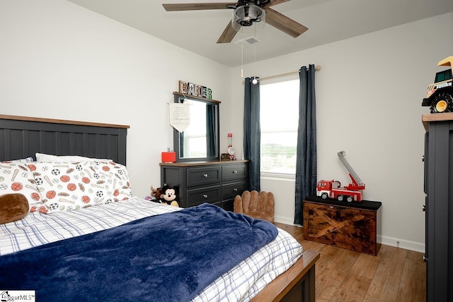 bedroom featuring hardwood / wood-style flooring, baseboards, and ceiling fan
