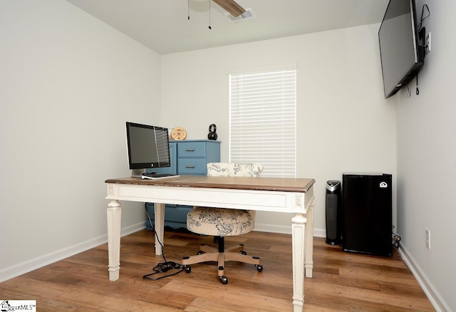 office area with a ceiling fan, light wood-style floors, and baseboards