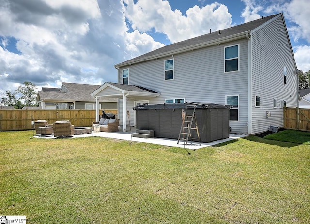 rear view of house featuring a hot tub, a patio, and an outdoor living space with a fire pit